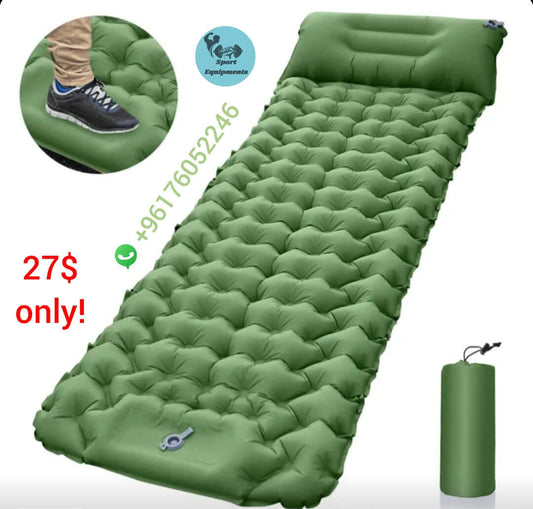 Green inflatable camping mattress with pump on a white background